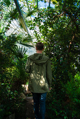 Naklejka na ściany i meble Teenager walking in botanical garden - Stock photo