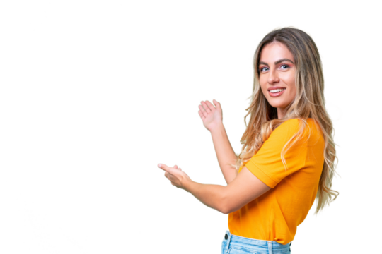 Young Uruguayan woman over isolated background extending hands to the side for inviting to come