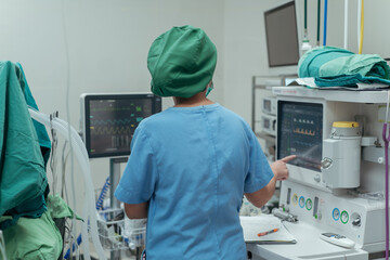 Anesthesiologist monitor the patient condition about the pulse rate of the patient on the screen. ...