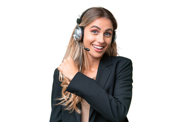 Telemarketer pretty Uruguayan woman working with a headset over isolated background celebrating a...