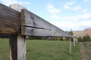 Fototapeta na wymiar Closeup view of old wooden fence outdoors
