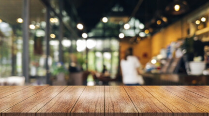 Empty wooden table top with lights bokeh on blur restaurant background.	
