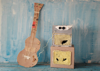 Grungy cardboard model of a guitar and an amp stack,music, live performance,grunge rock concept