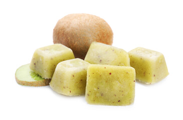 Frozen kiwi puree cubes and fruit on white background