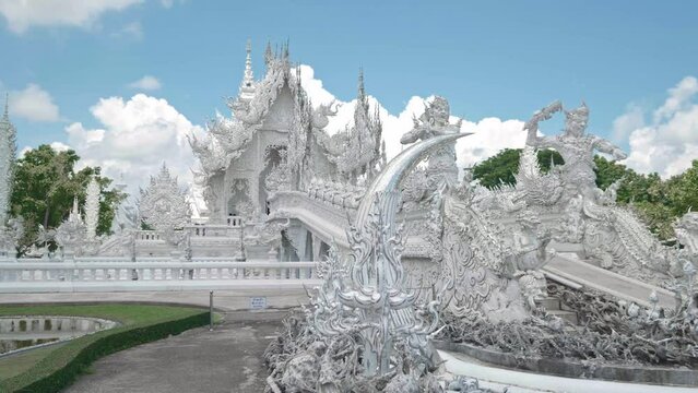 Beautiful architecture of religious buildings. Buddhist white temple Wat Rong Khun in northern Thailand.