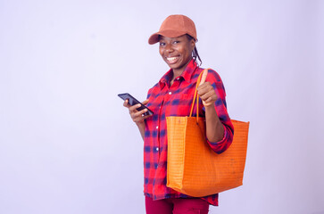 Beautiful African woman shopping online with mobile phone on banner background