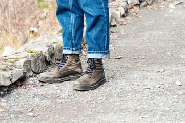 Tourist feet in boots on a mountain path