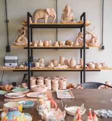 Ceramic toys on the shelves for sale at the workshop