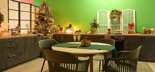 Cozy kitchen with dining table decorated for Christmas celebration