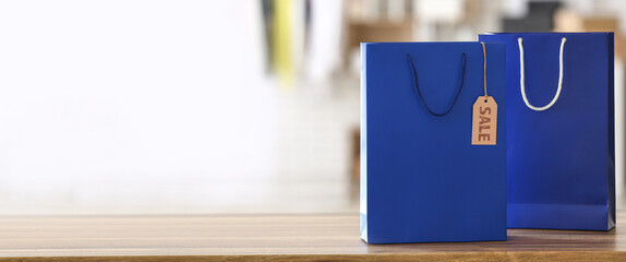Blue shopping bags on counter in store. Black Friday sale