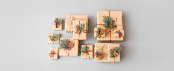 Christmas presents with fir branches on grey background