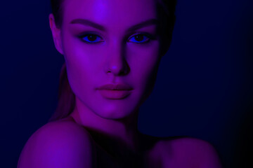 Woman on lilac neon background.