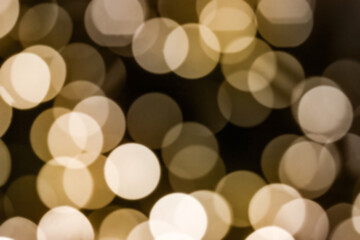 beautiful abstract background - highlights from a garland, a blurry image of a warm yellow bokeh