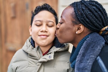 Fototapeta premium African american mother and son smiling confident standing together kissing at street