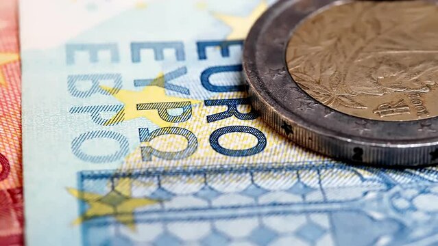 EU euro coins on a pile of euro banknotes. Economy and finance of the EU. Cash. Currency background. 