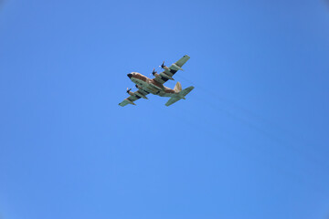 Modern airplane flying in blue sky