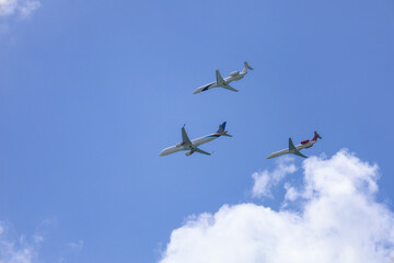 Modern airplanes flying in blue sky