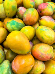 Tasty ripe mangoes as background, closeup