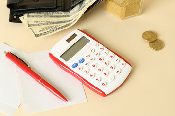 Calculator with pen and sticky notes on beige background, closeup. Budget concept