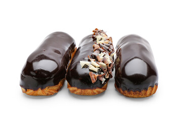 Delicious eclairs in chocolate glaze on white background