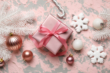 Composition with Christmas gift and decorations on color background