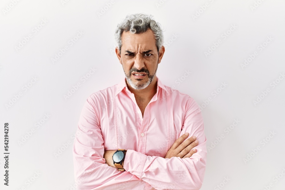 Canvas Prints Middle age hispanic man standing over isolated background skeptic and nervous, disapproving expression on face with crossed arms. negative person.