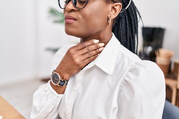 African american woman business worker suffering for throat pain working at office