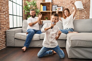 Family singing song using microphone at home