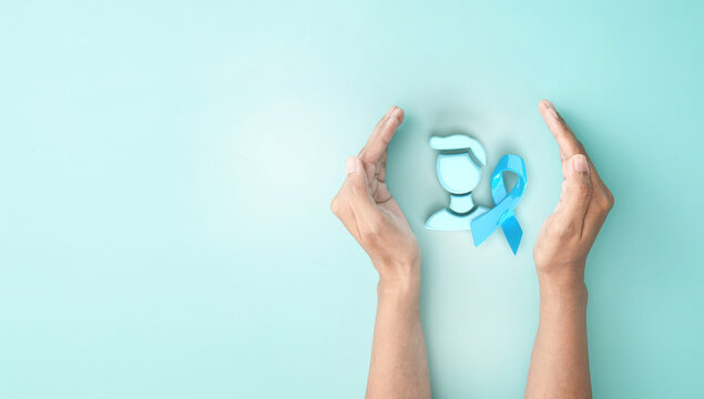 hand cover sign symbol of man iconic and light blue ribbon awareness on blue background for Prostate Cancer Day