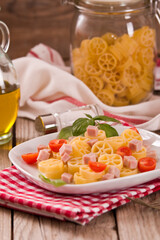 Ruote pasta with tomato and ham.
