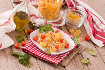 Ruote pasta with tomato and ham.