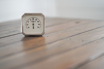 Antique thermometer on wooden table