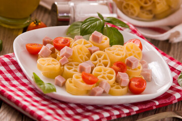 Ruote pasta with tomato and ham.