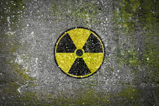 radiation warning sign on a moldy concrete wall