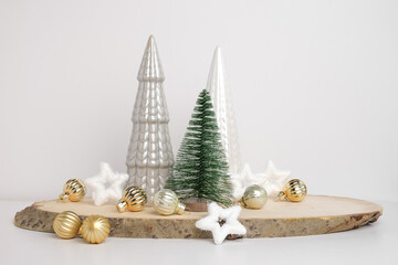 Modern Christmas trees. Decorative Beige, White and Green Christmas Decoration on a Wooden Stand with a Gray background. Nordic Festive Decor. Boho, Scandinavian Style Design. Trendy Minimal Ornament.