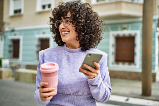 Young middle east woman smiling confident using smartphone at street