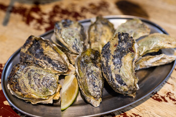 Grilled oyster with lemon dish