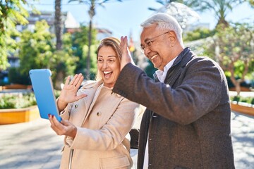 Middle age man and woman couple smiling confident having video call at park