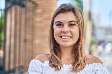 Young woman smiling confident standing at street