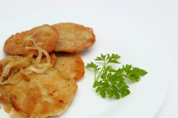 Potato pancakes or latkes or draniki on white plate. Top view. Copy space. Fried potato pancakes