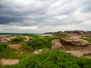 The rock field or rock shore with the green grass called Han Hong is famous in the middle of the Mekong river during the dry season.