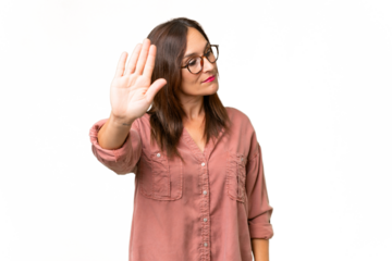 Middle-aged caucasian woman over isolated background making stop gesture and disappointed