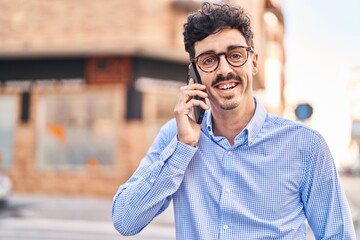 Young caucasian man smiling confident talking on the smartphone at street