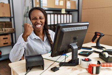 African woman working at small business ecommerce angry and mad raising fist frustrated and furious while shouting with anger. rage and aggressive concept.