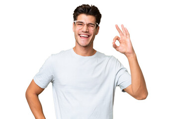 Young caucasian handsome man over isolated background showing ok sign with fingers - obrazy, fototapety, plakaty