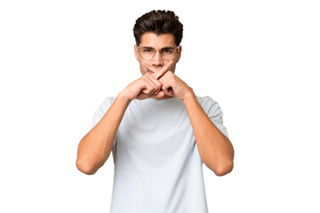 Young caucasian handsome man over isolated background showing a sign of silence gesture