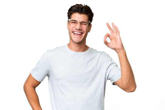 Young caucasian handsome man over isolated background showing ok sign with fingers