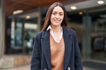 Fototapeta premium Young beautiful hispanic woman smiling confident standing at street