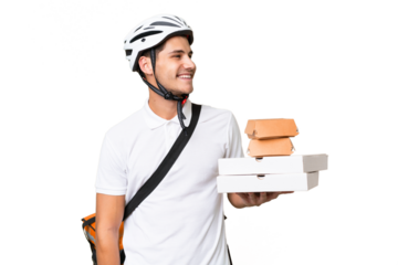 Young caucasian man with thermal backpack over isolated background looking side