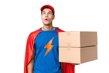 Super Hero delivery man over isolated background looking up and with surprised expression